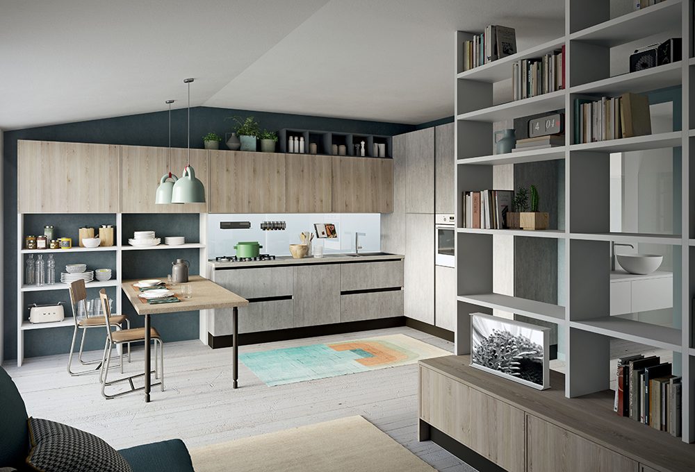 Nel monolocale la cucina a vista con scaffali e penisola